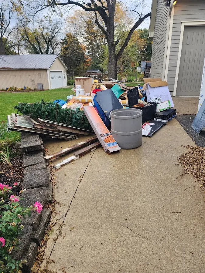 Dumpster being loaded with debris for 12 Yard Dumpster Rental in Granite Shoals